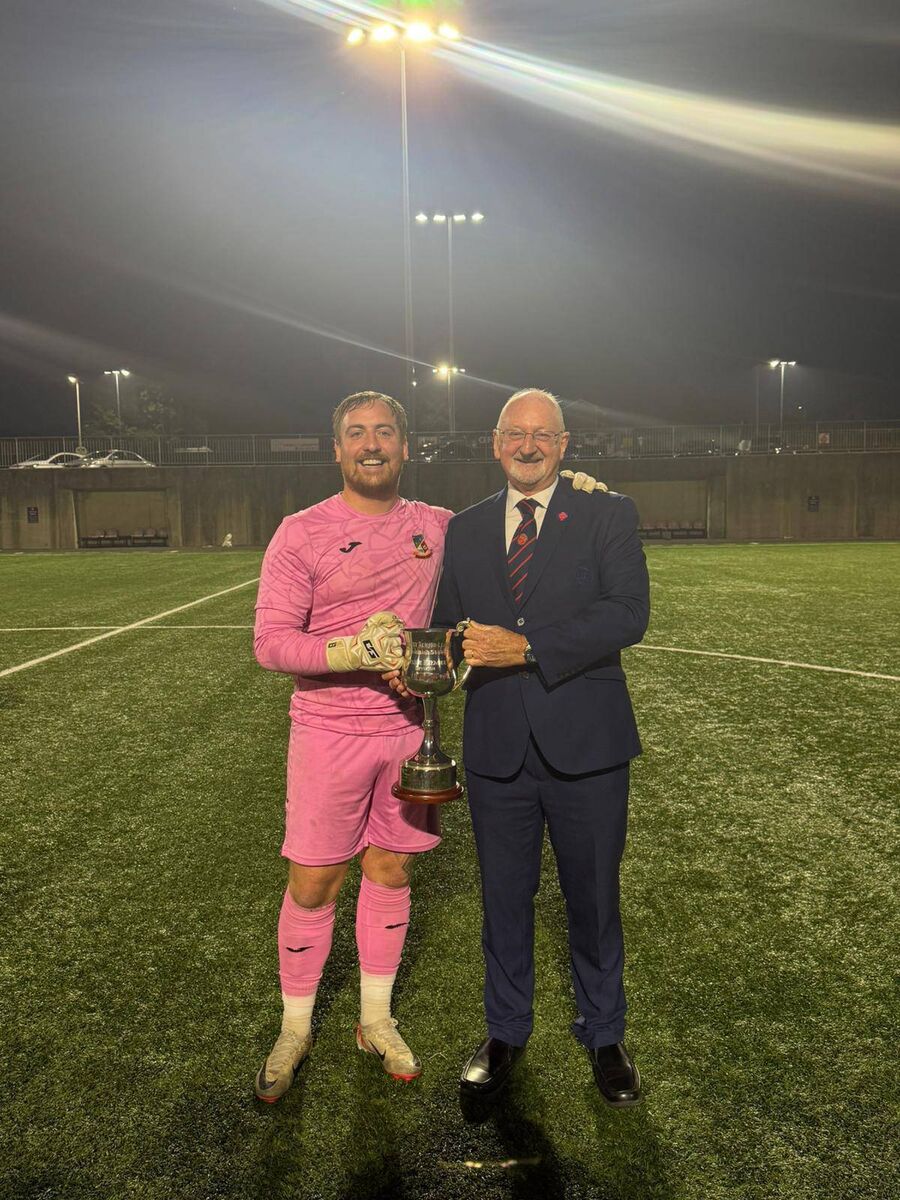 Pat Quinn, Munster Senior League, presents the Beamish Stout Junior Premier Division trophy to Ringmahon captain Cian O'Connor. Pat Quinn, Munster Senior League, presents the Beamish Stout Junior Premier Division trophy to Ringmahon captain Cian O'Connor.
