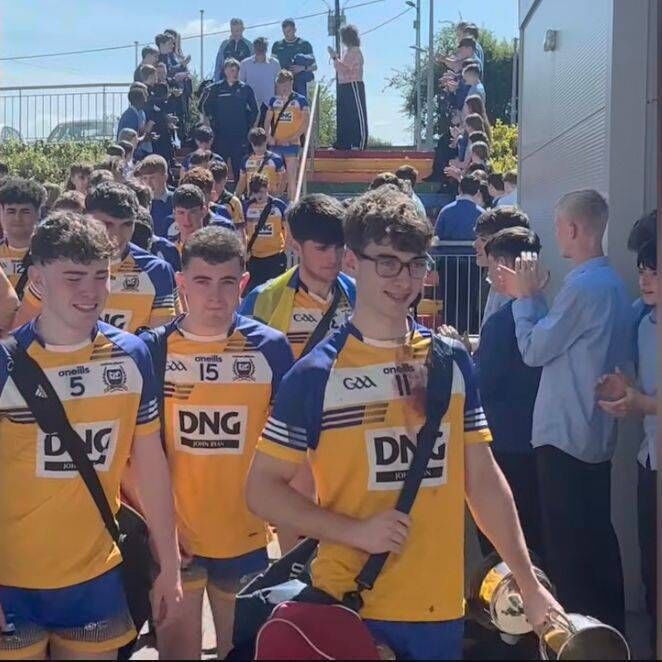 Players entering the Coláiste Mhuire school to a guard of honour from their peers after winning the Cork PPS Senior C football championship.