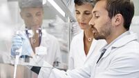 Scientists doing cancer research in laboratory