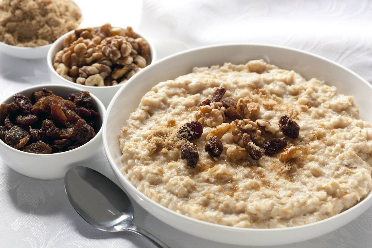 Oatmeal with raisins, walnuts, and brown sugar. Delicious traditional porridge.