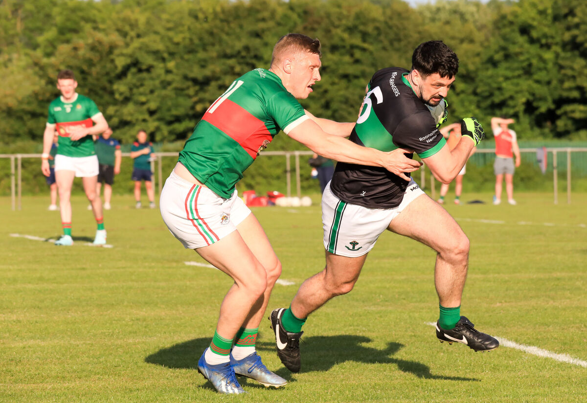 Nemo's Kevin Fulignati tries to get away from Clon's Sean White. Picture: David Creedon Nemo's Kevin Fulignati tries to get away from Clon's Sean White. Picture: David Creedon