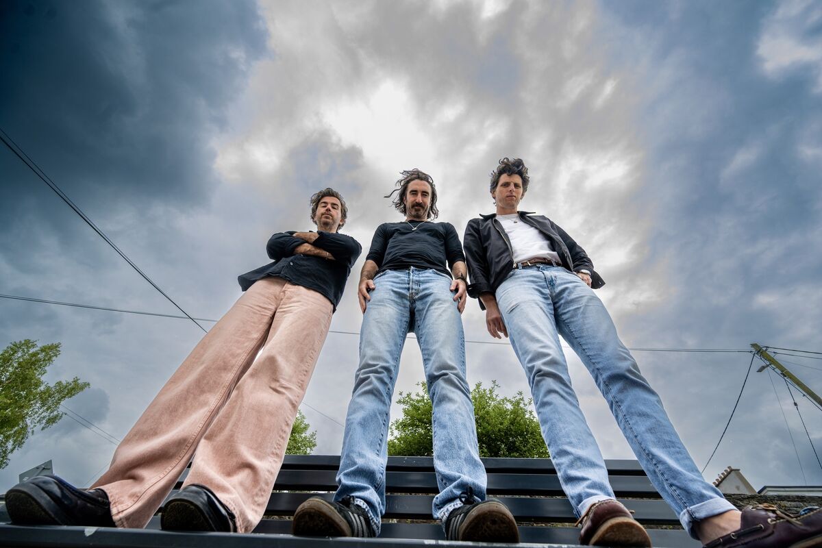 Graham Knox, Danny O’Reilly and Conor Egan of The Coronas loom large under stormy Cork skies. Picture Chani Anderson