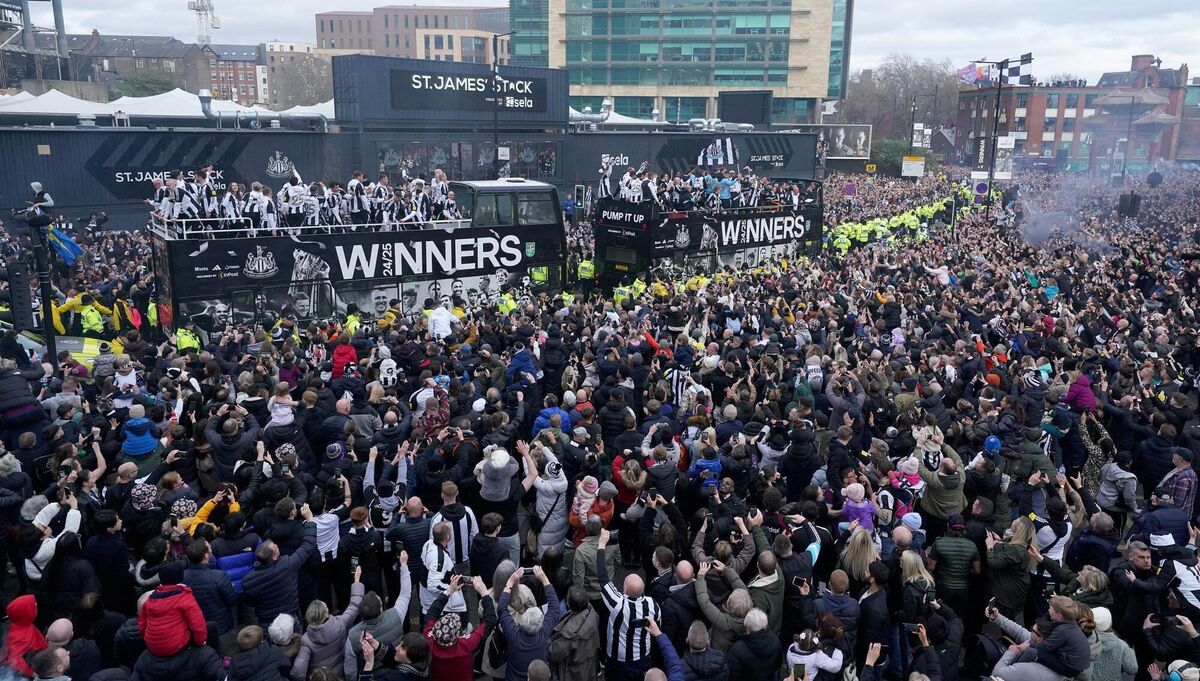 The open top buses carrying the Newcastle United players passes by fans outside St James' Park, during the Carabao Cup trophy parade in Newcastle. Picture: Owen Humphreys/PA Wire.