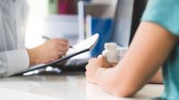 Sick patient visiting doctor in health care center or emergency room. Woman in appointment and meeting with physician or nurse.