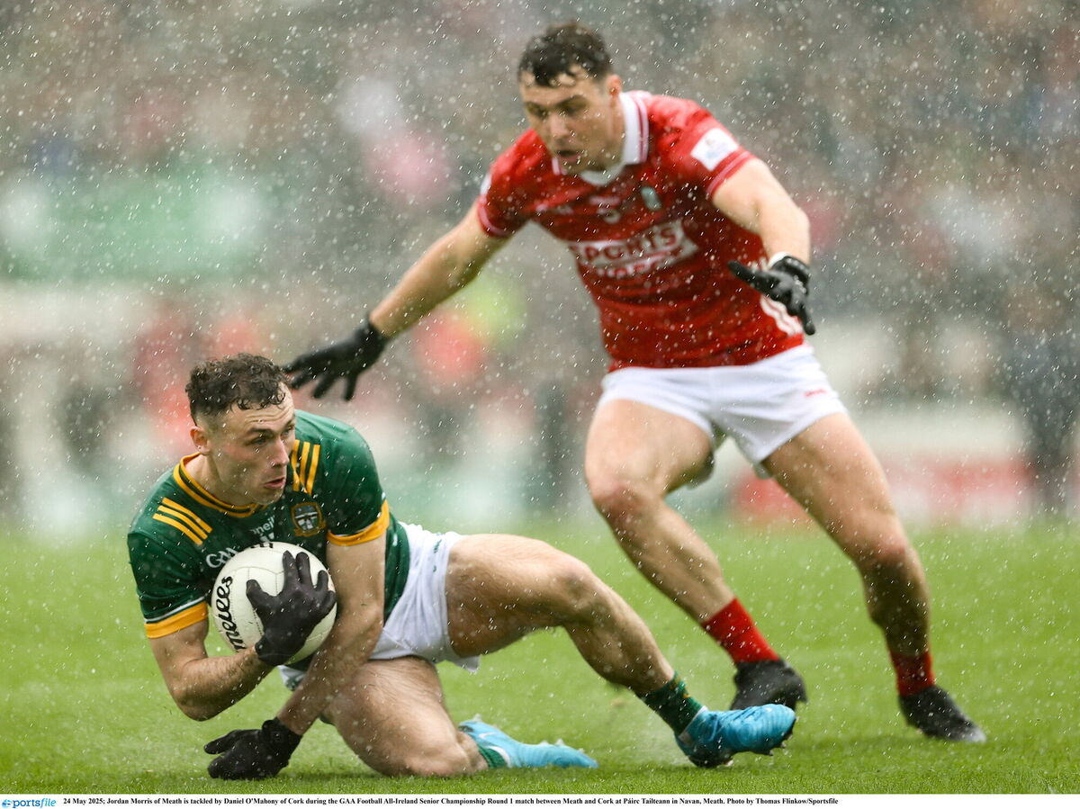 Jordan Morris of Meath is tackled by Daniel O'Mahony of Cork. Picture: Thomas Flinkow/Sportsfile