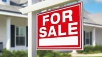 For Sale Real Estate Sign in Front of New House.
