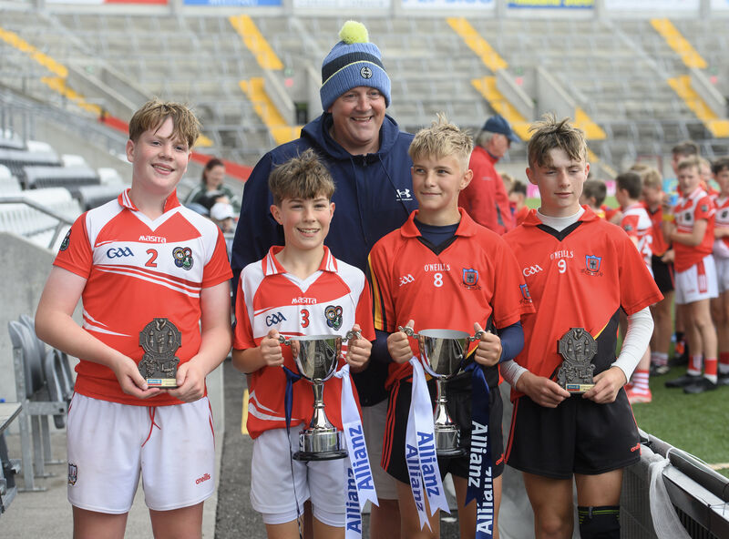  Conna captain Ólan Sheehan and Ballinadee captain Shay Forde with vice-captains Alex Keane and Tony O'Mahony holding the their trophies after they shared the spoils in the Allianz Sciath na Scol Chorcaí DH7 final at Supervalu Páirc Uí Chaoimh. Former Cork player Seanie Farrell made the presentation. Picture Dan Linehan