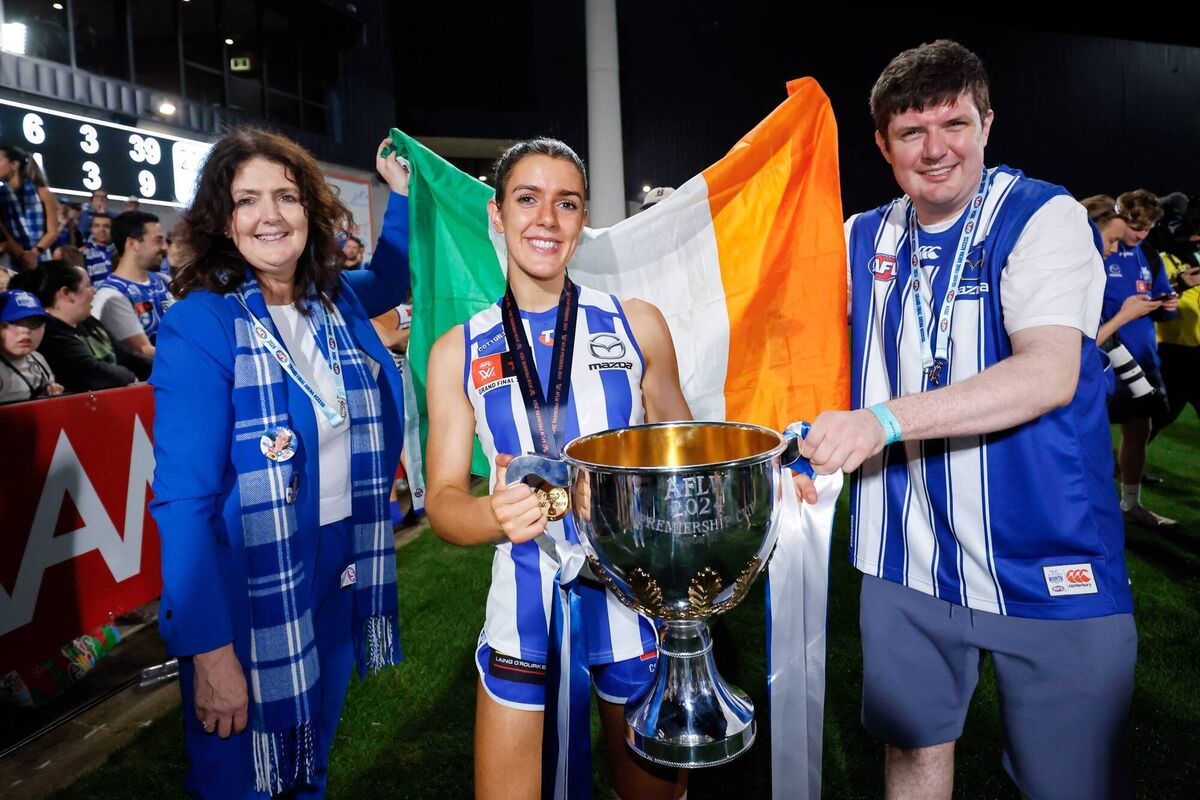 Erika O'Shea celebrates the Kangaroos AFLW Grand Final win with her mother, Maria, and brother, John.