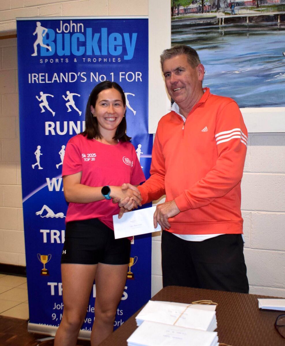 Holly Carroll, first in the women's race at the John Buckley Sports 5km, receiving her prize from Conor Kavanagh. Picture: John Walshe 
