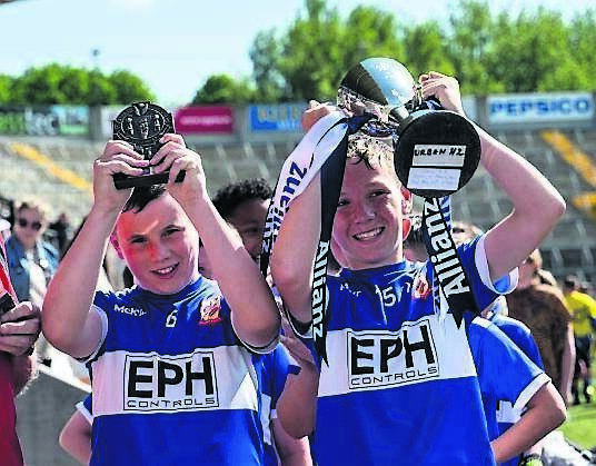 Togher Boys’ National School captains Zach Duffy and Sri Pranith Malla hold the cup aloft after their side’s win in the Urban Hurling 2 final of the Allianz Sciath na Scol competition at Páirc Uí Chaoimh.	Picture: Chani Anderson
                    