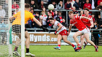 Noah Grimes scores a point despite the efforts of Cormac McKeown and Keelin Martin 28/5/2025