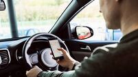 Midsection of man using mobile phone in car