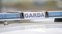 Garda sign and blue lights on a Garda car.