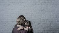 Girl hugging mother.
