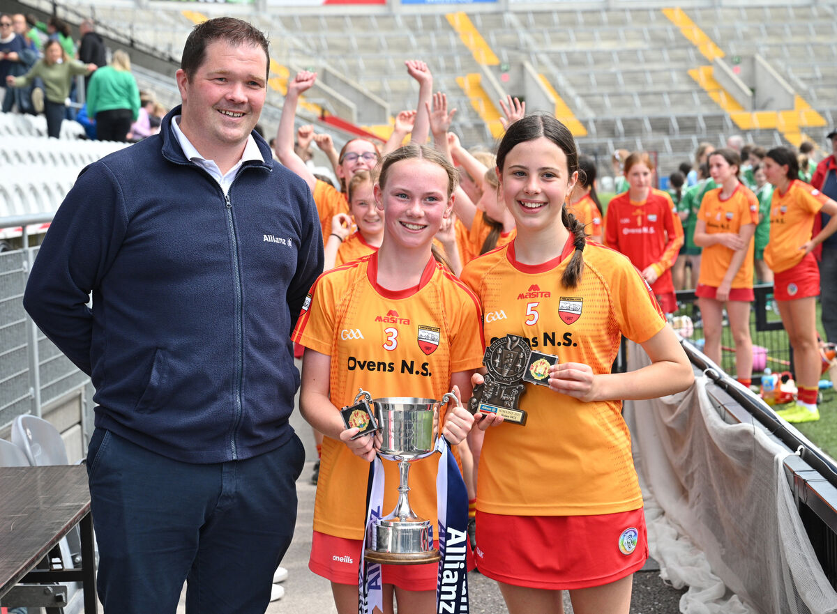 Rebecca Regan, captain, and Molly O'Brien, vice-captain, from Ovens NS with Martin McKeogh of Allianz after winning the Sciath na Scol. Picture: Larry Cummins Rebecca Regan, captain, and Molly O'Brien, vice-captain, from Ovens NS with Martin McKeogh of Allianz after winning the Sciath na Scol. Picture: Larry Cummins