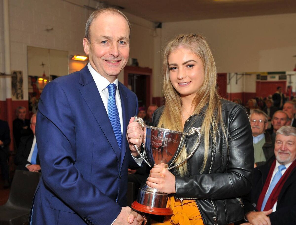 Taoiseach Micheal Martin presents Leanne Murphy of Togher BC with the 'Champion Of Champions' Perpetual Cup, a trophy named in honour of his late father Paddy 'The Champ' Martin. Picture: Doug MInihane