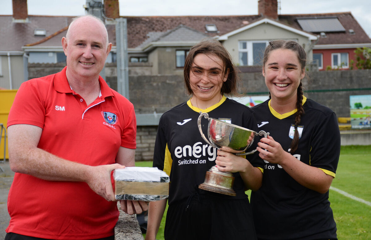 Stephen Mulcahy, CWSSL, presents the CWSSL Challenge Cup to Riverstown joint captains Shannon Carson and Aoife O'Brien following their teams victory over Wilton in the final played in St Colman's Park. Picture: Howard Crowdy