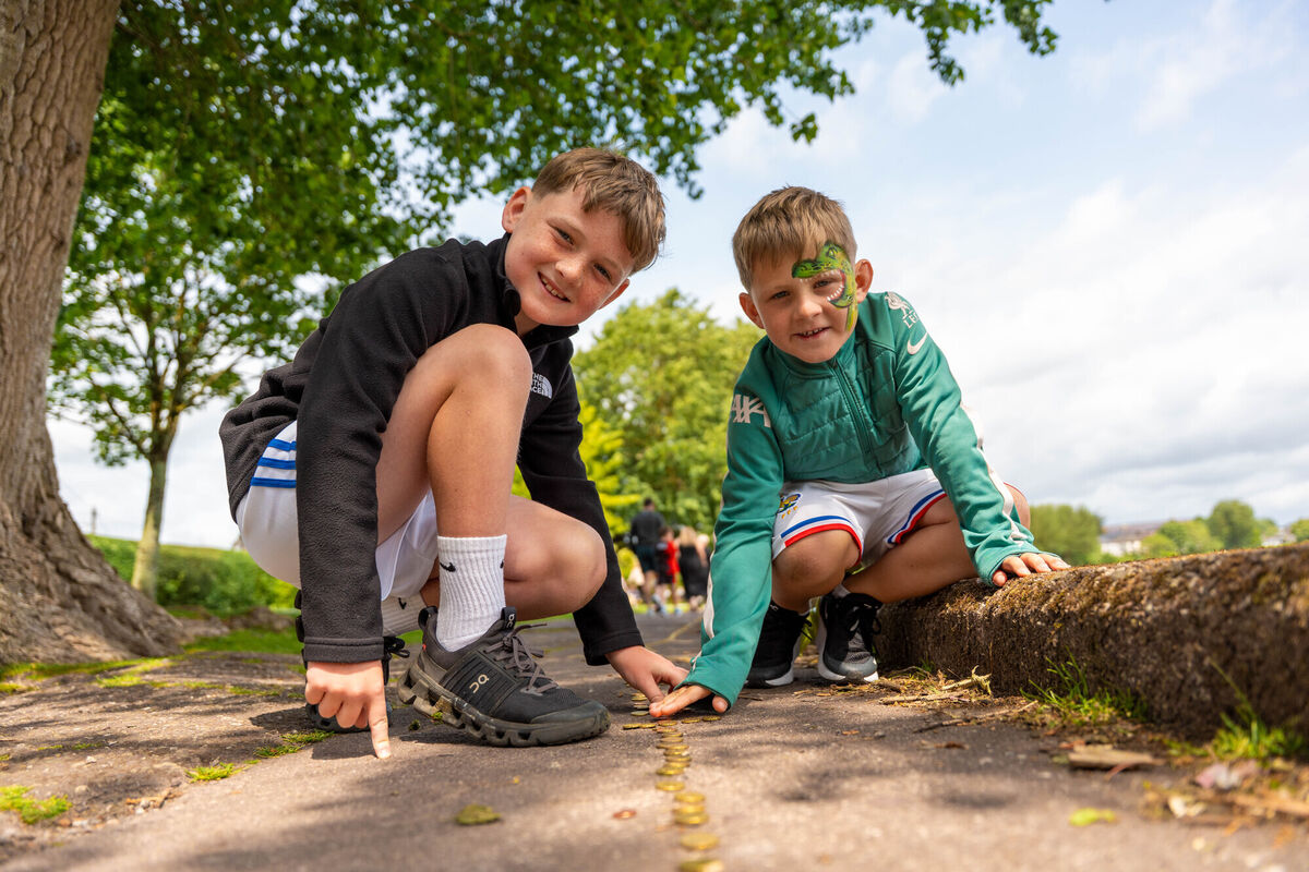 Darragh and James Horgan from Glanmire placing a coin around the Lough. Picture by Noel Sweeney