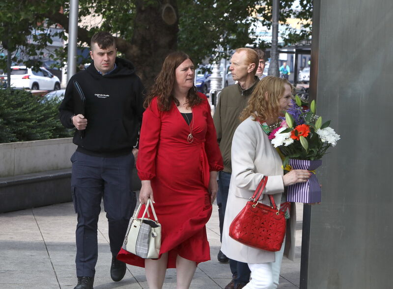 Members of the Howard family holding flowers  arriving at the court today.
