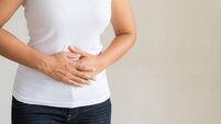 Young woman having painful stomachache. Chronic gastritis. Abdomen bloating concept.