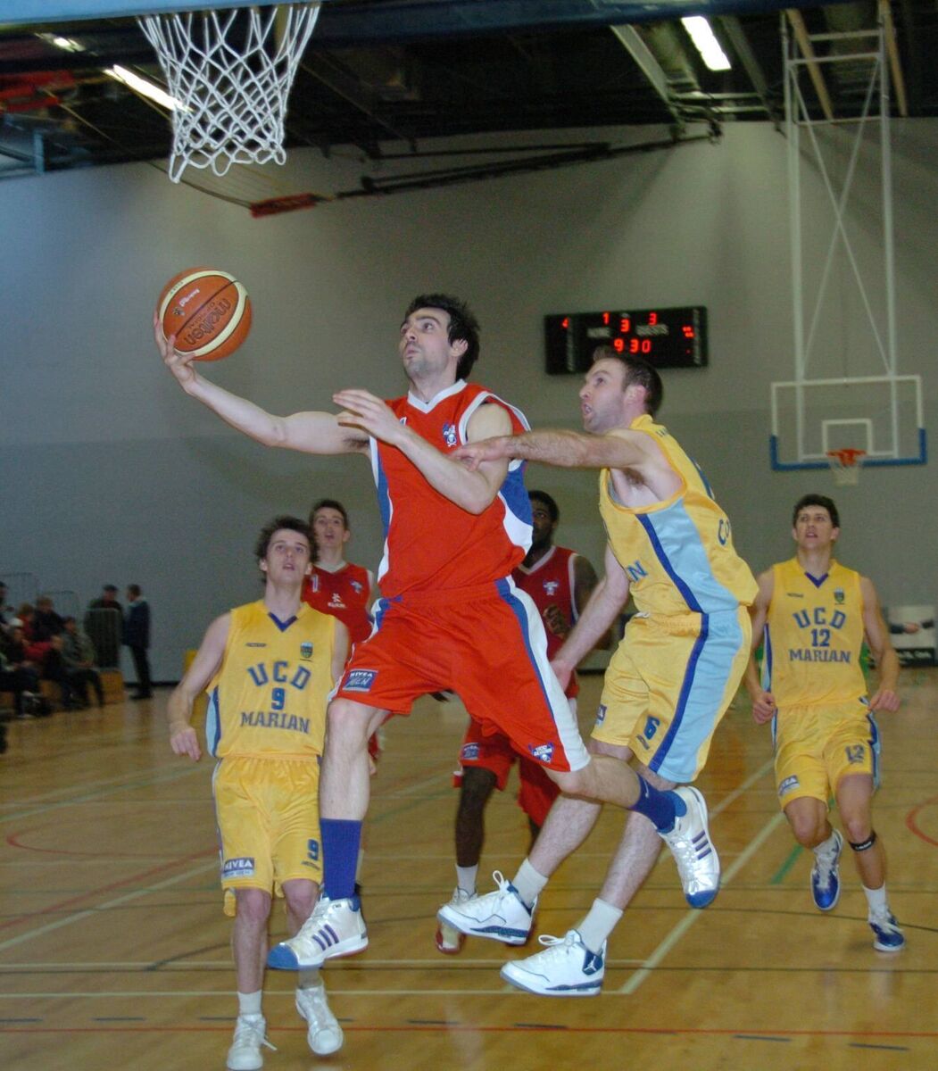 UCC Demons' Niall Murphy going for a score despite UCD Marian's Niall Meany during the Superleague game at the Mardyke Arena. 
