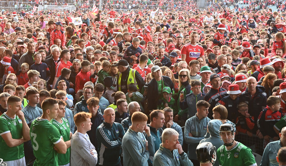 Cork fans celebrate with the dejected Limerick players in the bottom. Picture: Eddie O'Hare