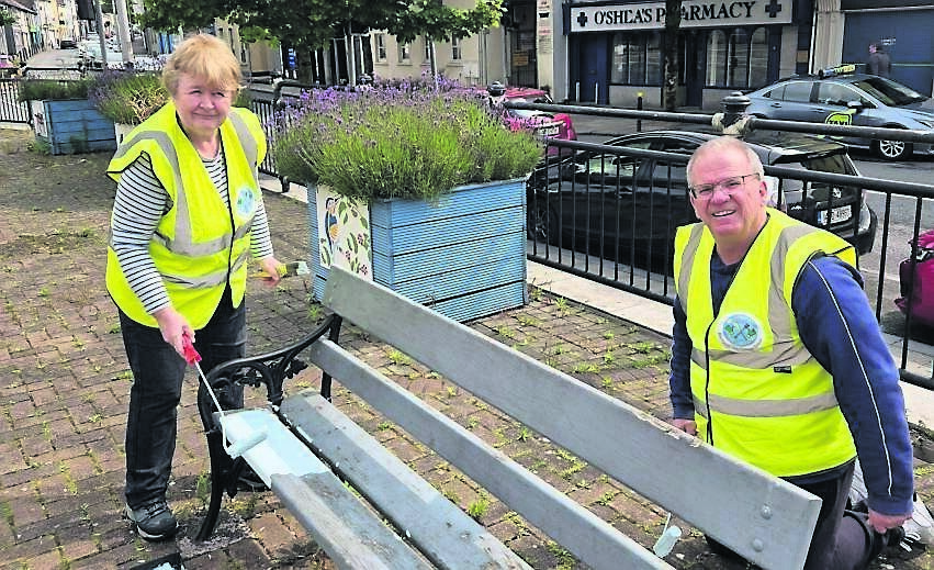 Blackpool Tidy Village Group volunteers giving a bench a fresh lick of paint.