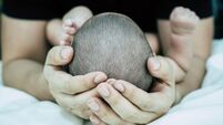 Baby sleeps in fathers hand,selective focus