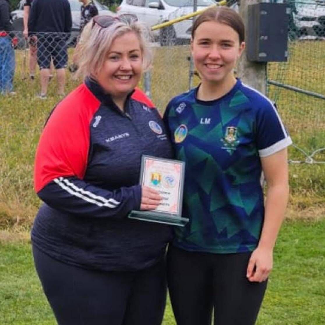 Lexi Manley, U16 Cork Poc Fada winner, is presented with her trophy by Maired Lynch, development officer, Cork Camogie Board.