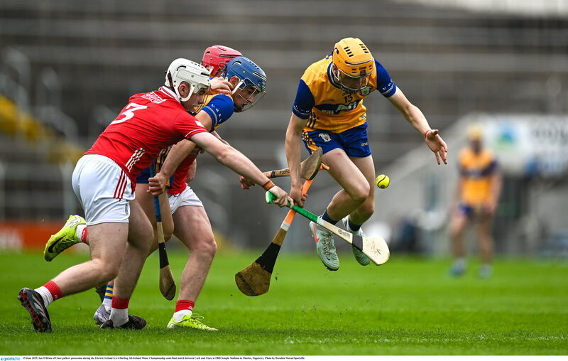 Cork full-back Denis Fitzgerald contests possession against an O'Brien of Clare. Picture: Brendan Moran/Sportsfile