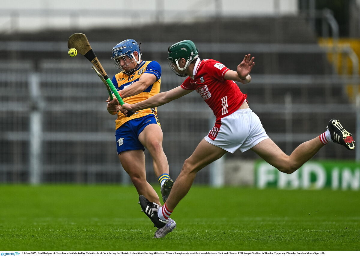 Cork's Colm Garde blocks down Paul Rodgers of Clare. Picture: Brendan Moran/Sportsfile