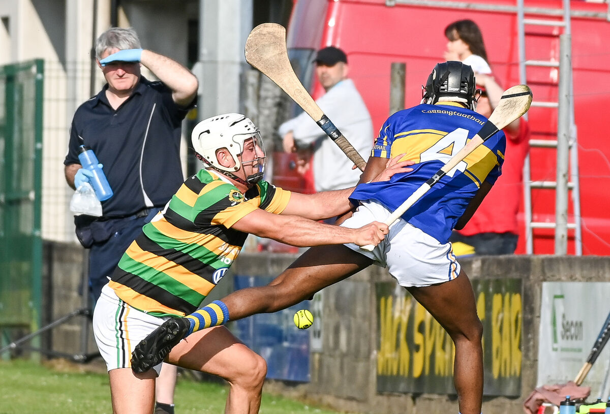  Carrigtwohill's David Joseph and Glen Rovers' Lee Quilligan, tussle for possession.