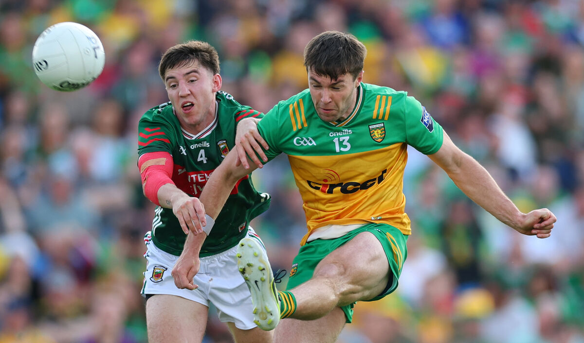 Donegal's Conor O'Donnell gets the ball away under pressure from Enda Hession of Mayo. Picture: Inpho/James Crombie
