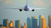 Passenger jet airliner plane arriving or departing Tampa International Airport in Florida at sunset or sunrise