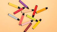 Disposable e-cigarettes, different flavors in orange. The concept of alternative smoking, vaping and artificial nicotine vapor s