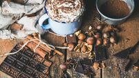 Hot chocolate with whipped cream, nuts, spices, cocoa powder