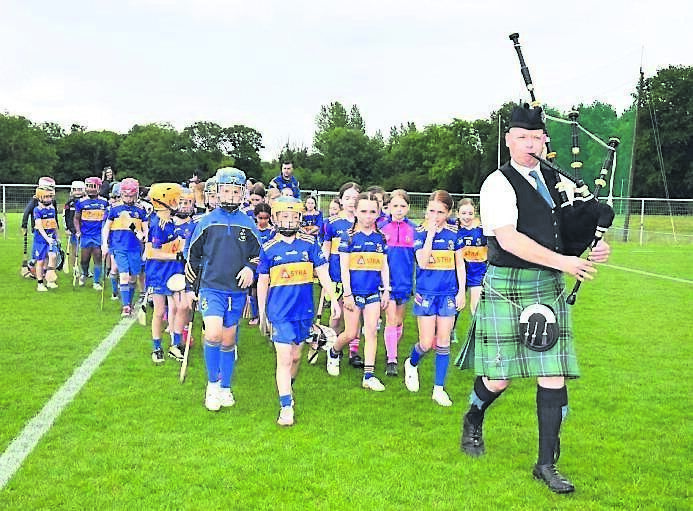 Piper Jason Deasy leading the U9 juvenile players, at the official opening of Carrigaline GAA Juvenile Pitches, in memory of Billy Walsh. Piper Jason Deasy leading the U9 juvenile players, at the official opening of Carrigaline GAA Juvenile Pitches, in memory of Billy Walsh.
