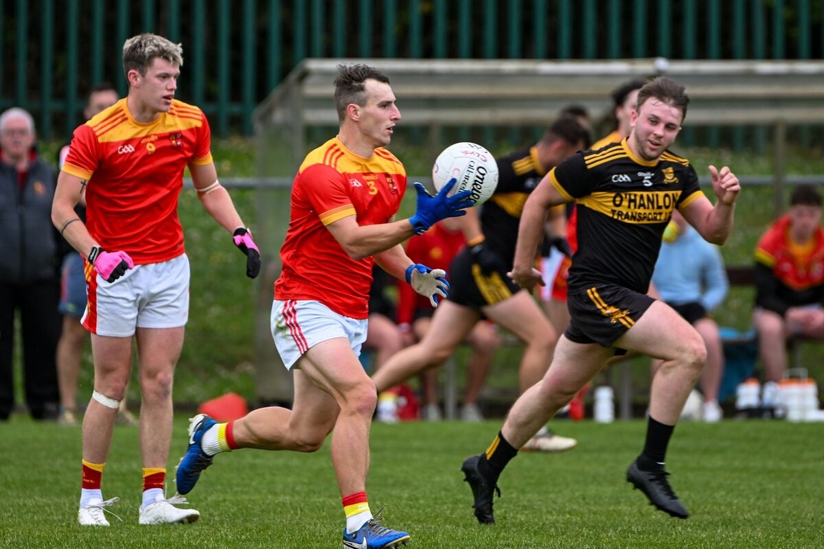 Mallow’s Paul Lyons carries the ball forward under pressure from Clyda Rovers’ Dara Buckley. Picture Chani Anderson