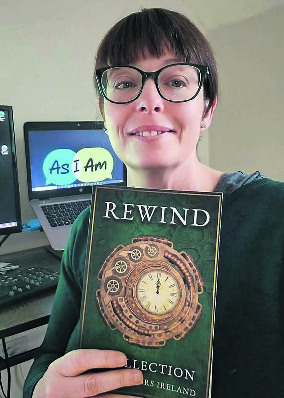 Claire O’Connor of Indie Authors Ireland with a copy of the Rewind anthology, which will raise money for the AsIAm autism charity