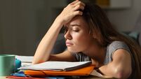 Tired student trying to study in the night