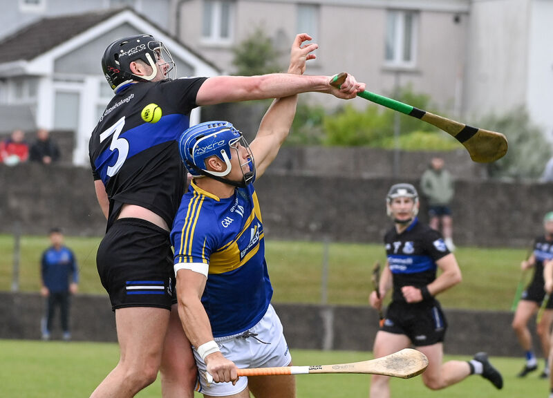  Sarsfields' Kieran Walsh battles with Carrigtwohill's Sean Walsh, during their SHL clash at Carrigtwohill.