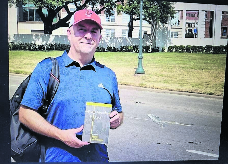 Cork author Martin McSweeney with his novel, Two Weeks In June, at Dealey Plaza in Dallas - the ‘X’ on the road behind him is where President Kennedy was fatally shot Cork author Martin McSweeney with his novel, Two Weeks In June, at Dealey Plaza in Dallas - the ‘X’ on the road behind him is where President Kennedy was fatally shot