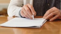 Hands of senior retirement woman writing a finance savings budget plan on paper or legal trust fund for after her funeral. Elder