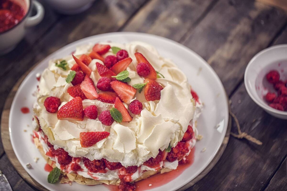 This berry pavlova is topped with fresh, seasonal berries- a taste of summer.