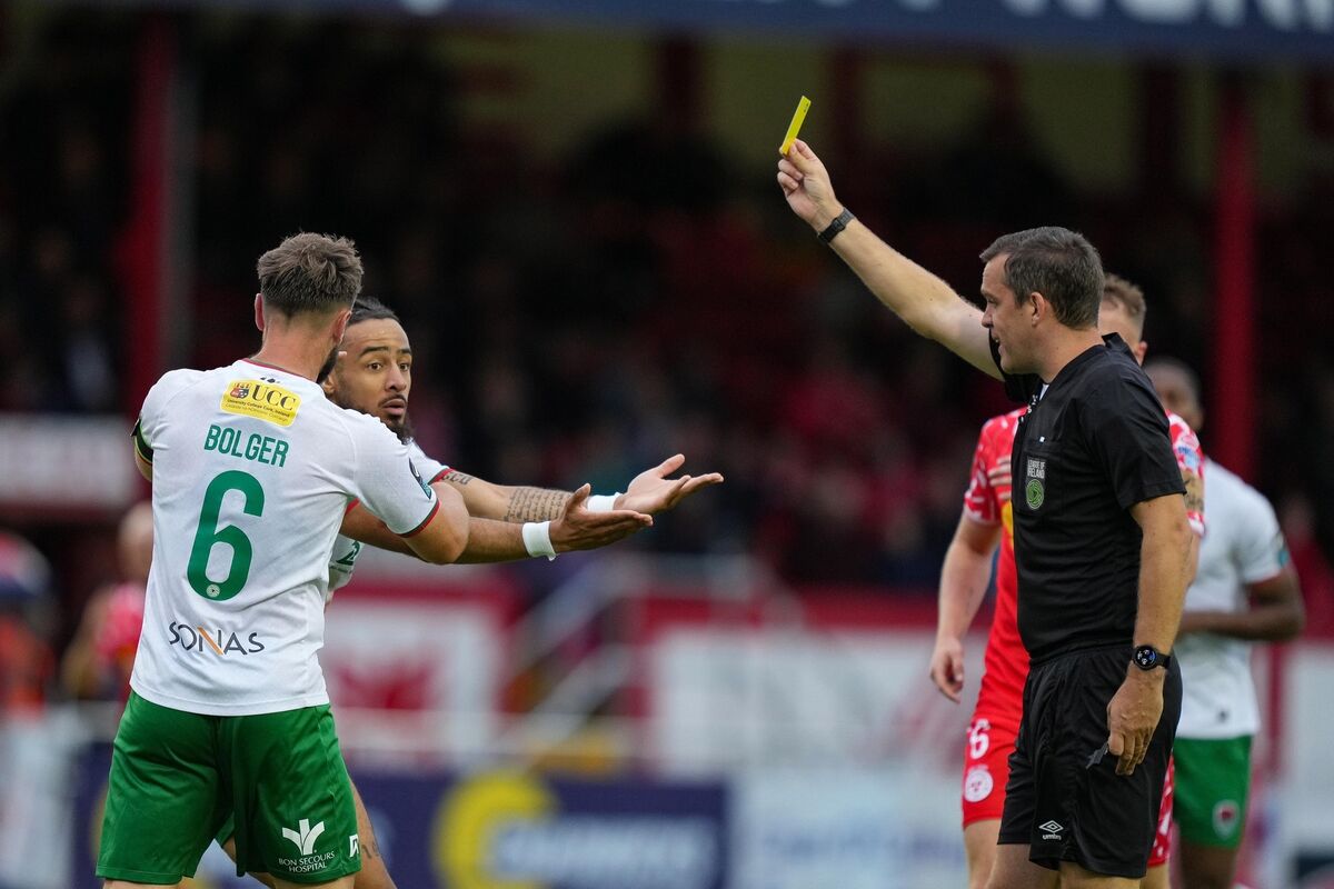 Shelbourne vs Cork City: Milan Mbeng of Cork City receives a yellow card from referee Rob Harvey