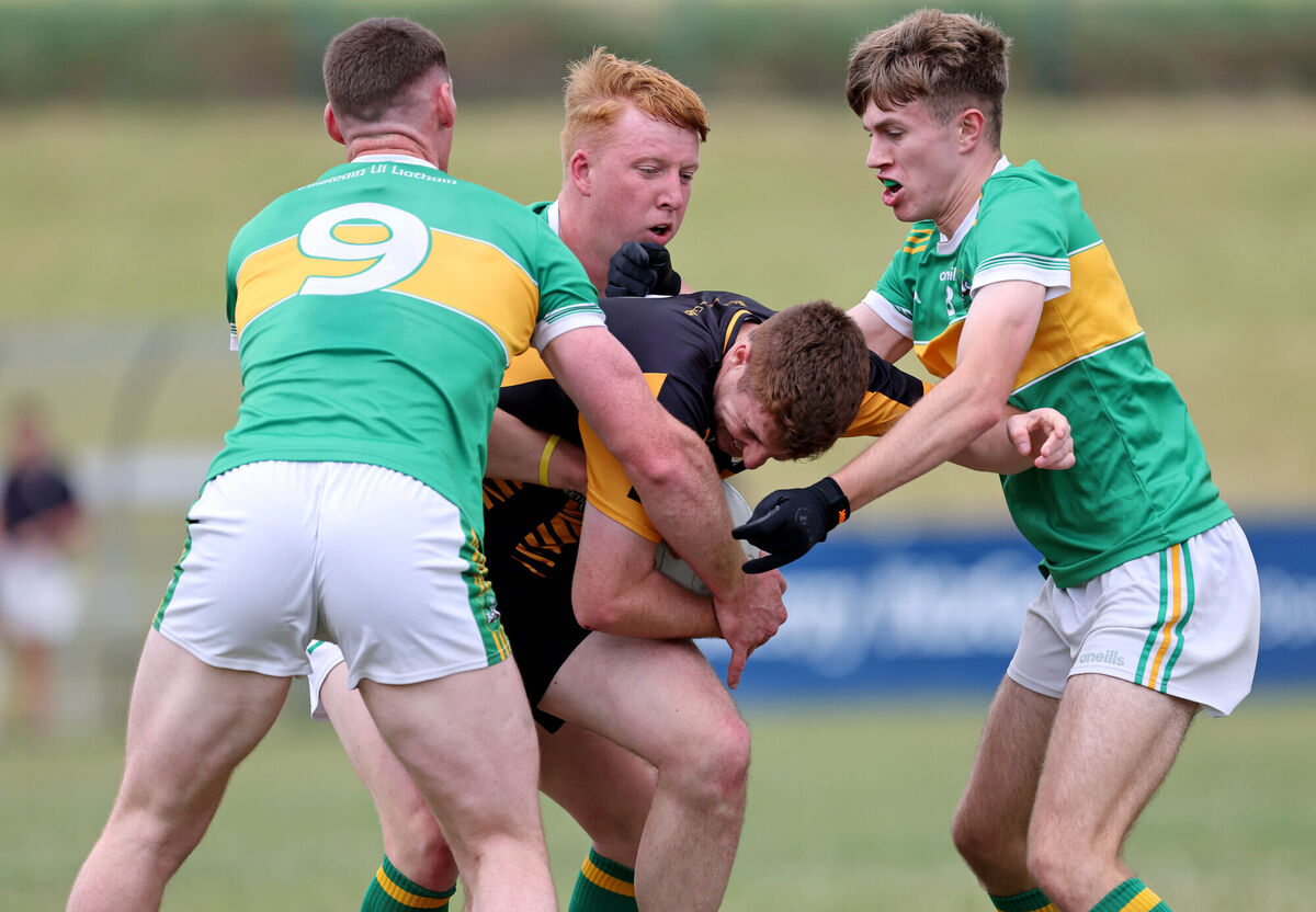  Shane Moroney, Matthew Rosner and Dylan Leetch of Castlelyons challenge Ian McAuliffe of Rochestown. Picture: Jim Coughlan