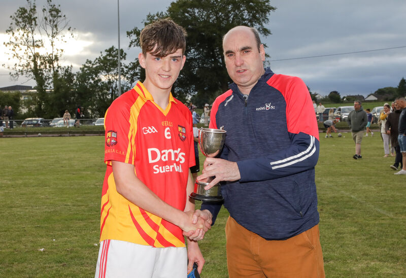 Steven Lynch of Rebel Óg presents the cup to Mallow captain Ben Galvin after their win over St Finbarr's. Picture: David Creedon