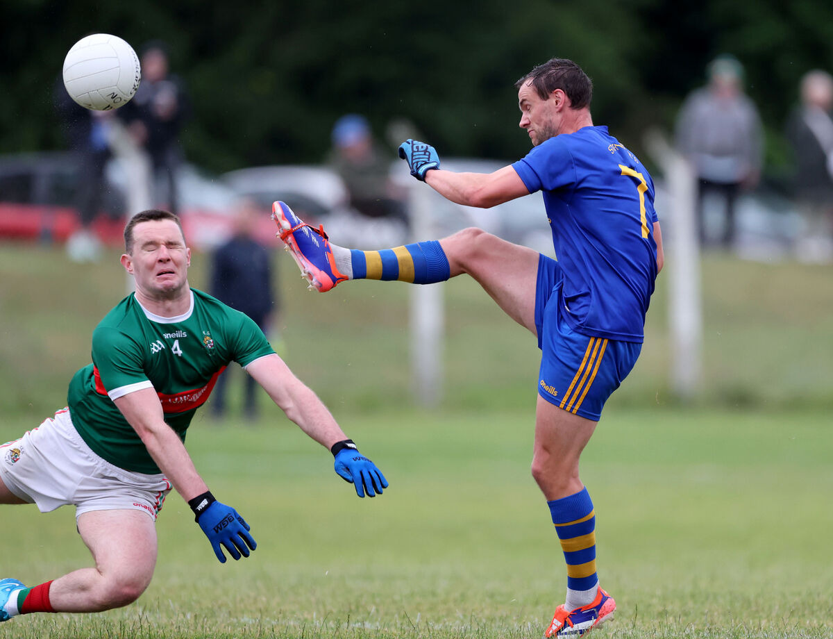  Enda Dennehy, St.Finbarrs, kicks the ball while Maurice Shanley, Clonakilty watches on. Picture: Jim Coughlan.