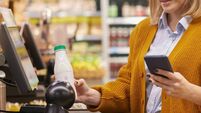 Woman Scanning Groceries at Self Checkout in Supermarket