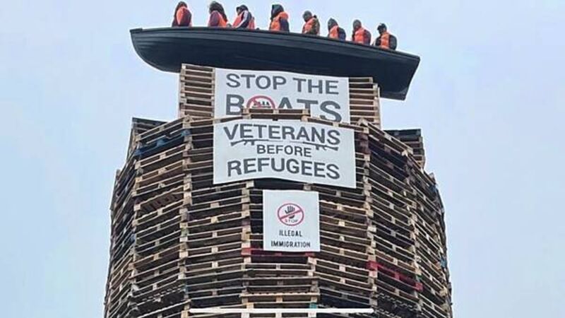 Calls for removal of migrant effigies in boat placed on loyalist bonfire in NI Calls for removal of migrant effigies in boat placed on loyalist bonfire in NI